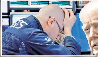  ??  ?? TAKING STOCK OF THINGS: A trader at the New York Stock Exchange looks rattled Friday (above) amid President Trump mulling an additional $10 0 billion in tariffs on Chinese imports and China’s Commerce Ministry countering it’s “fully prepared to hit back forcefully and without hesitation.”