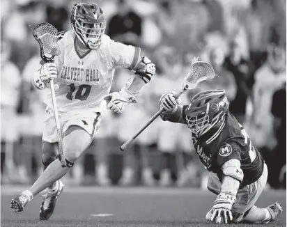  ?? DANIEL KUCIN JR./BALTIMORE SUN ?? Calvert Hall’s Grant Mitchell, left, tries to get around a St. Mary’s player Friday during the MIAA A boys lacrosse title game.