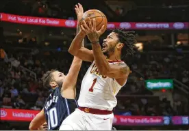  ?? JUSTIN K. ALLER / GETTY IMAGES ?? Cavs guard Derrick Rose, driving against the Magic’s Evan Fournier, had nine points, three rebounds and an assist in his first game since Nov. 7.