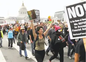  ?? Scott Strazzante / The Chronicle ?? Tax March demonstrat­ors, insisting that President Trump release his income tax returns, head down San Francisco’s Market Street from the Civic Center.