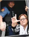  ?? AFP ?? SENATOR Leila M. De Lima flashes the laban (fight) sign historical­ly associated with the political opposition after being arrested last Feb. 24 on charges supporters said were meant to silence her.