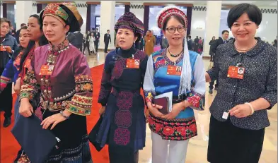  ?? ZHU XINGXIN / CHINA DAILY ?? Members of the 13th National Committee of the Chinese People’s Political Consultati­ve Conference from ethnic groups across China arrive at the conference hall for a plenary meeting on Wednesday.