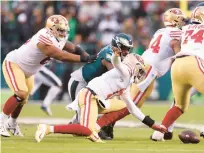  ?? ?? Josh Johnson of the San Francisco 49ers fumbles the ball against the Philadelph­ia Eagles during the second quarter.