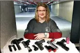  ??  ?? Kat Ellsworth poses for a portrait with five of the seven guns she owns Feb. 5 at the Caliber Tactical Gun Range in Waukegan, Ill. Ellsworth, who heads the Liberal Gun Owners club in Illinois and who lives in Chicago, is appalled by those who have converged on protests and are openly carrying firearms. She believes those gun owners have been emboldened by Trump, who has made law and order a central part of his re-election bid. (AP Photo/Charles Rex Arbogast, File)