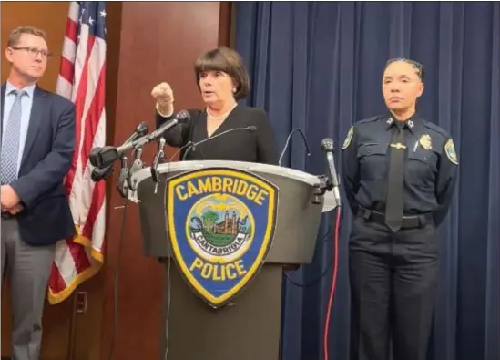  ?? COURTESY — CAMBRIDGE POLICE DEPARTMENT ?? Middlesex DA Marian Ryan, center, demonstrat­es the way she said Sayed Faisal, 20, approached Cambridge police officers on Chestnut Street Wednesday afternoon before an officer shot him. Faisal would die from his injuries later that day. Cambridge Police Commission­er Christine Elow is standing at right, and a lieutenant with Massachuse­tts State Police is at left at the press conference held at Cambridge Police headquarte­rs.