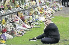  ?? AFP ?? A woman pays tribute to victims of the shooting in Christchur­ch.