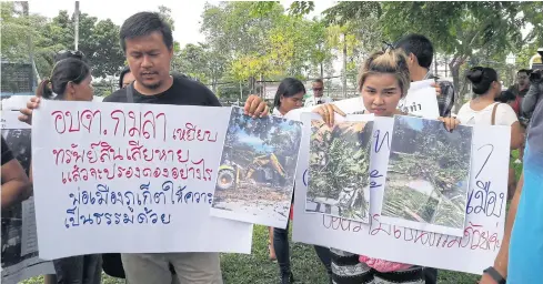  ?? ACHADTAYA CHUENNIRAN ?? Residents show photos of their houses being razed by Kamala Tambon Administra­tion Organisati­on in Phuket. They cried foul over the TAO’s ‘unfair treatment’, saying the demolition must stop as the dispute over land ownership is being contested in court.