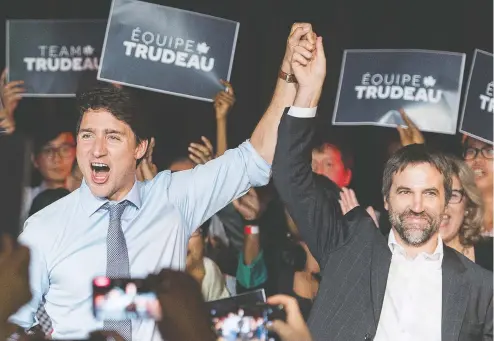  ?? GRAHAM HUGHES / THE CANADIAN PRESS VIA ASSOCIATED PRESS ?? Prime Minister Justin Trudeau raises the hand of Steven Guilbeault at an event to launch his candidacy for the Liberal party of Canada in Montreal on Wednesday. Guilbeault will run in the riding of Laurier-Sainte-Marie.