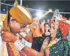  ??  ?? A Pakistani Hindu couple performs a Hindu ritual during a mass wedding ceremony in Karachi. — AFP photo