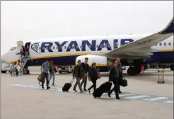  ?? The Associated Press ?? Passengers disembark from a Ryanair plane at the Marseille Provence airport in Marignane, southern France.