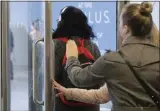  ?? MARK LENNIHAN — THE ASSOCIATED PRESS ?? Women hold a door open as they exit a subway station Wednesday, March 4, in New York.