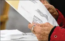  ?? BEN GRAY/ASSOCIATED PRESS ?? During the pandemic, the accessibil­ity of absentee ballots and early voting was a relief for health care workers and patients alike, but bills being considered could change that.