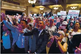  ?? ANDREW HARNIK — THE ASSOCIATED PRESS ?? Supporters react as President Donald Trump speaks at a Latinos for Trump Coalition roundtable at Arizona Grand Resort & Spa in Phoenix on Monday.