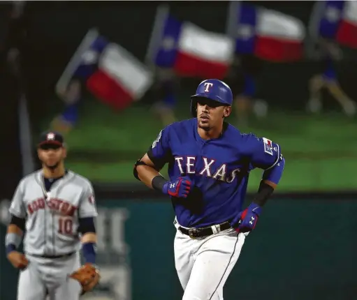  ?? Ronald Martinez / Getty Images ?? The Rangers’ Ronald Guzman takes a jog after producing a tying two-run homer in the eighth inning Friday. It was one of nine home runs in the game.