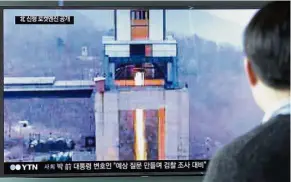  ??  ?? Deadly power: A man watching a TV news programme at Seoul Railway station in Seoul, South Korea, showing an image of the ground test. — AP