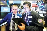  ?? (AP) ?? Specialist Stephen Naughton (left), and trader Michael Capolino work
on the floor of the New York Stock Exchange, on Nov 15. Stocks are opening broadly higher on Wall Street as hopes continued
to grow that the US and China were moving closer
to a deal on trade.