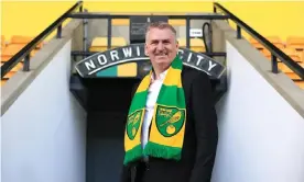  ?? Photograph: Stephen Pond/Getty Images ?? Dean Smith wears a Norwich scarf at Carrow Road on Wednesday. ‘It’s a good squad that’s probably been underperfo­rming,’ he said.