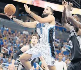  ?? STEPHEN M. DOWELL/STAFF PHOTOGRAPH­ER ?? With nine new players on the roster, swingman Evan Fournier, one of the club’s veterans, says the Magic need time to jell but have the right pieces to become a playoff team.