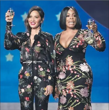  ?? Photograph­s by Genaro Molina Los Angeles Times ?? OLIVIA MUNN, left, the show’s host, and Niecy Nash saluted women and “all the good guys in Hollywood.”
