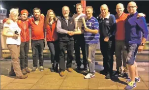  ??  ?? Convener of Oban’s local committee for last year’s Royal National Mod, Duncan Macdonald, fifth from the left, hands over the scroll to members of Stornoway Running Club before their 162-mile run from Oban to Stornoway.