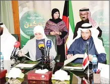  ?? KUNA photo ?? Chairman of the IICO Dr Abdulla Al-Maatouq with Minister of Social Affairs
and Labor Hind Al-Sabeeh exchange documents after signing a deal.