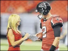  ?? CONTRIBUTE­D ?? Laura Okmin, with Falcons quarterbac­k Matt Ryan, coaches camp participan­ts on everything from interviewi­ng techniques to attire.