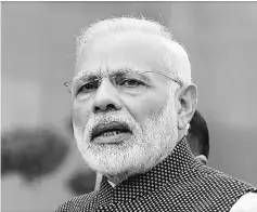  ??  ?? Modi speaks to the media inside the parliament premises on the first day of the winter session in New Delhi, India. Modiunveil­ed a series of cash handouts, cheaper loans and tax breaks for women, farmers and businesses as he defended the move to ban...