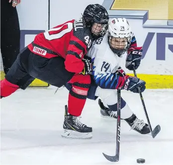  ?? LIAM RICHARDS/THE CANADIAN PRESS ?? Canada forward Blayre Turnbull and U.S. forward Brianna Decker battle for the puck during the 4 Nations Cup preliminar­y game in Saskatoon Wednesday, which the U.S. won 2-1.