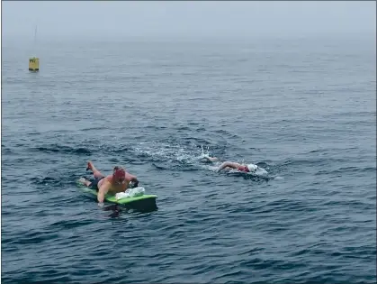  ?? PHOTOS CONTRIBUTE­D ?? Greg Gubser accompanie­s former Cal swimmer Catherine Breed, 27, to the completion of her 25-mile Monterey Bay solo swim on Tuesday. Breed is the fifth female to successful­ly swim across the Monterey Bay.