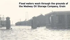  ?? ?? Flood waters wash through the grounds of the Medway Oil Storage Company, Grain