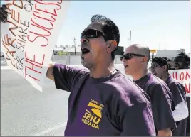  ?? David Guzman ?? Las Vegas Review-journal @davidguzma­n1985 Jesse Mendiola, a member of the Service Employees Internatio­nal Union, pickets outside the Las Vegas Review-journal offices June 19.