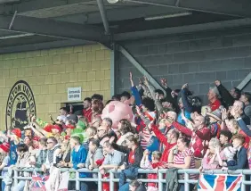  ?? ?? The Boro fans, many in fancy dress, cheer on the visitors.