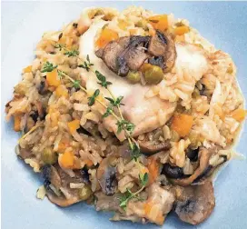  ?? PHOTO/ELIZABETH KARMEL] [AP ?? This chicken and rice recipe was prepared in a pressure cooker in under an hour.