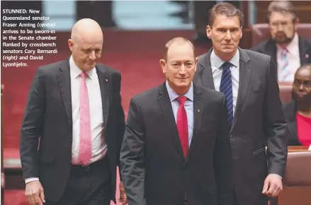  ?? STUNNED: New Queensland senator Fraser Anning arrives to be sworn- in in the Senate chamber flanked by crossbench senators Cory Bernardi
and David Lyonhjelm. ?? ( right) ( centre)