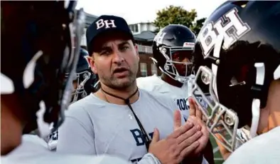  ?? KEN MCGAGH FOR THE GLOBE ?? New Belmont Hill coach Anthony Fucillo huddles up his charges during practice.