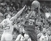  ?? Rick Bowmer Associated Press ?? LOU WILLIAMS, who’s been leading the NBA in scoring since Dec. 22, nets 31 vs. Raul Neto and Utah.