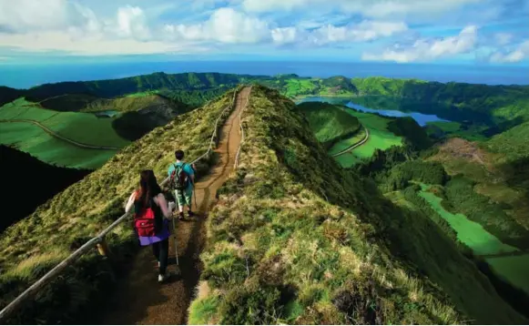  ?? FERNANDO RESENDES/VISIT AZORES ?? Walking trails in the Azores cater to everyone from leisurely strollers to hardcore hikers. The view from some trails is a breathtaki­ng mix of rolling peaks and the ocean.