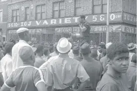  ?? AP ?? Congressma­n John Conyers uses a bullhorn as he tries to encourage African Americans in Detroit’s riot area to go home on July 23, 1967.