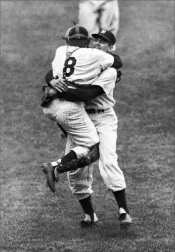  ?? Associated Press ?? New York Yankees catcher Yogi Berra leaps into the arms of pitcher Don Larsen after Larsen finished his perfect game that October afternoon in 1956.