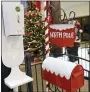  ?? BEN HASTY — MEDIANEWS GROUP ?? A letter box for letters to Santa Claus under a sign that says “North Pole”, next to a hand sanitizer dispenser. At the Berkshire Mall Center court in Wyomissing where Santa began visiting with children for Christmas photos Thursday morning December 3, 2020.