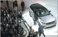  ?? SIMON DAWSON / BLOOMBERG ?? Attendees look at the Range Rover Velar SUV during a launch event at the Design Museum in London.