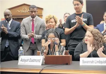  ?? CHIP SOMODEVILL­A/GETTY ?? Aalayah Eastmond, a 17-year-old senior at Marjory Stoneman Douglas High School who was shielded by a classmate who died from his wounds during the Parkland school shooting last February, wipes away tears as she receives a standing ovation while testifying to the House Judiciary Committee in Washington on Wednesday.