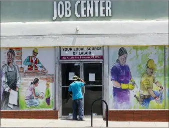  ?? THE ASSOCIATED PRESS ?? A person looks inside the closed doors of the Pasadena Community Job Center in Pasadena, Calif., during the coronaviru­s outbreak. California’s unemployme­nt rate continued to climb in May, reaching 16.3% as businesses continued to lay people off because of a state-at-home order aimed at slowing the spread of the coronaviru­s that has wrecked the state’s economy.