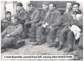  ??  ?? >
Jack Reynolds, second from left, among other British PoWs