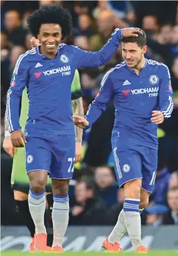  ?? — AFP ?? Chelsea’s Willian (left) celebrates a goal with teammate Eden Hazard during their FA Cup fifth-round match against at Stamford Bridge in London on Sunday. Chelsea won 5-1.