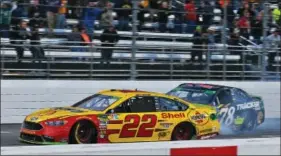  ?? AP PHOTO BY STEVE HELBER ?? Joey Logano (22) approaches the finish line as Martin Truex Jr. (78) follows as he wins the Monster Energy NASCAR Cup Series auto race at Martinsvil­le Speedway in Martinsvil­le, Va., Sunday, Oct. 28.