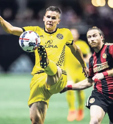  ?? AP ?? Columbus Crew defender Jukka Raitala (left) takes possession of a long pass during the second period of extra time of an MLS play-off game against Atlanta United, in Atlanta on Thursday. Columbus advanced after beating Atlanta 3-1 on penalties.