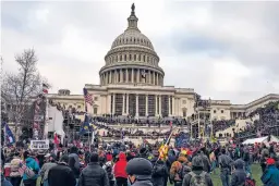  ?? JASON ANDREW/NEW YORK TIMES FILE PHOTO ?? A crowd of President Donald Trump supporters gathers to storm the Capitol in Washington on Jan. 6, 2021. At campaign rallies, Trump now refers to the Jan. 6 attacks as “a beautiful day” and said the roughly 1,240 people arrested so far in connection with the riot are “hostages,” not prisoners.