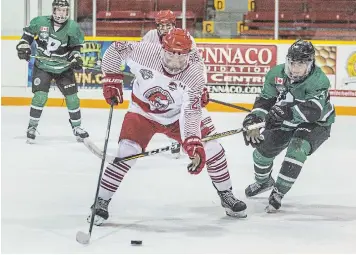  ?? BOB TYMCZYSZYN TORSTAR ?? St. Catharines’ Jordan Schanbache­r, middle, is checked by Pelham’s Cameron Savoie in Greater Ontario Junior Hockey League quarterfin­al action.