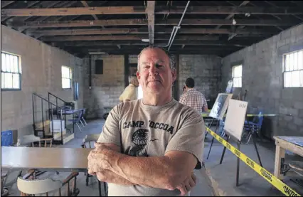  ?? HENRY TAYLOR PHOTOS / HENRY.TAYLOR@AJC.COM ?? Patrick Hall stands inside the remaining building at Camp Toccoa on the side of Currahee Mountain. Hall and his small band of colleagues, a nonprofit known as the Camp Toccoa at Currahee Project, want to turn it into an exhibit area, office and gift...